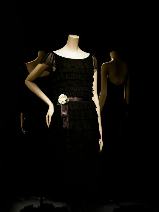 Mannequins dressed in black dresses in a dark room